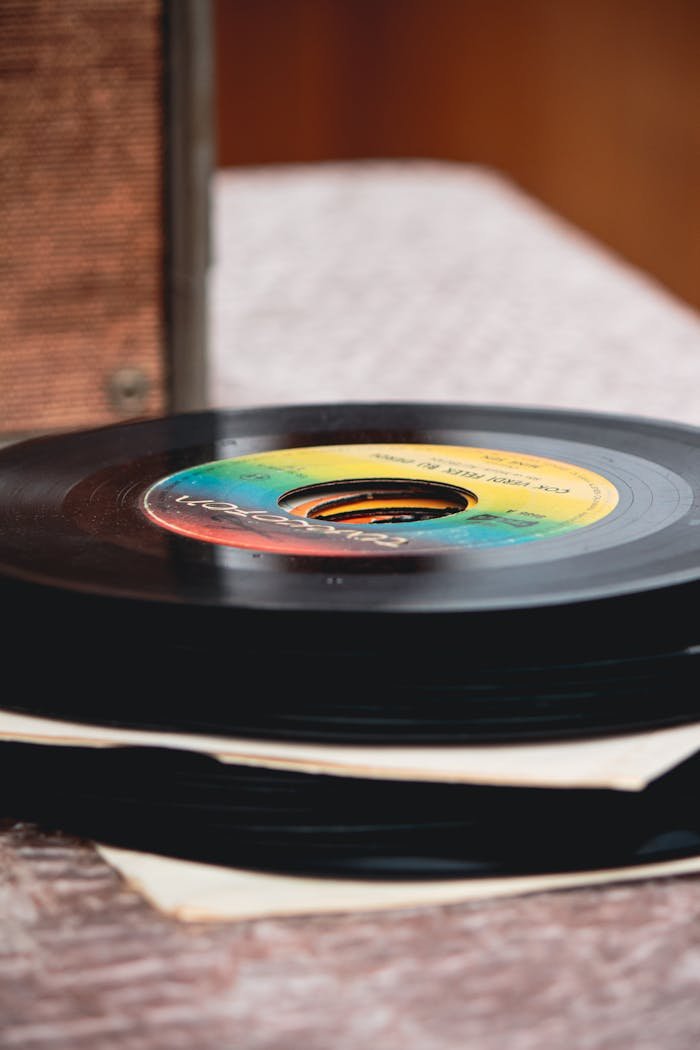 Crafting Captivating Headlines: Your awesome post title goes here Close-up of stacked vintage vinyl records on a rustic table, showcasing vibrant labels.